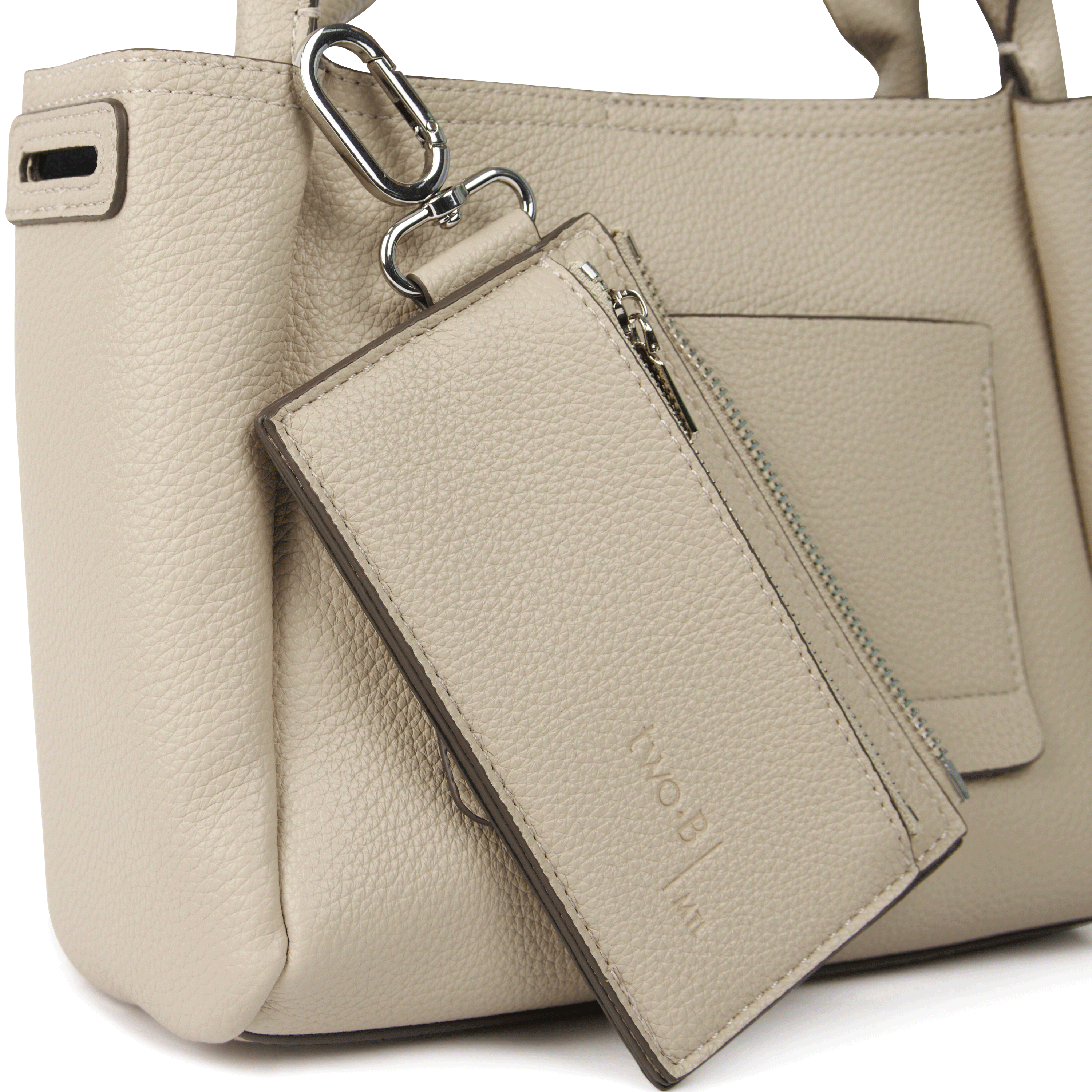 Beige leather handbag with a matching wallet and carabiner on a white background